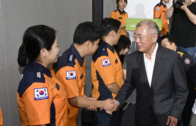 정의선(오른쪽 1번째) 현대차그룹 회장이 지난 6월 소방관 회복지원 수소전기버스 전달식에 참석해 소방관들과 악수하며 인사하고 있다. 현대차그룹 제공